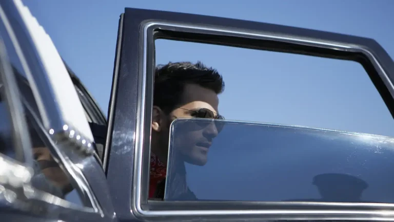 a man exits a car with tinted windows