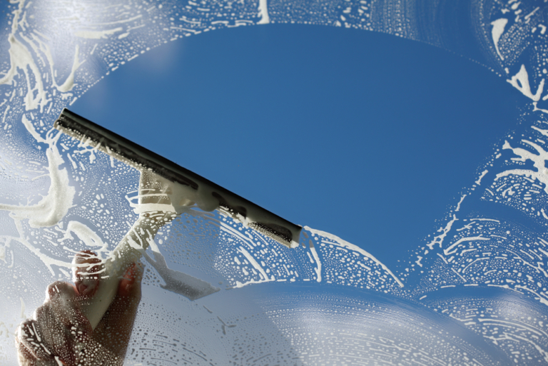 a squeegee is used to clean a window